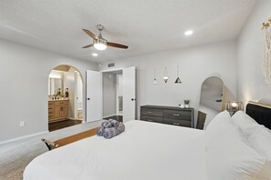 A bedroom with a bed, a ceiling fan, a dresser, and a mirror. - Best of Garland Pool, Cinema Rm, BBQ (Garland)