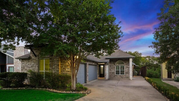 A residential house with a driveway, garage, and a well-maintained lawn. - Clearview Castle - Pool, Jacuzzi, Lake View (Lewisville)