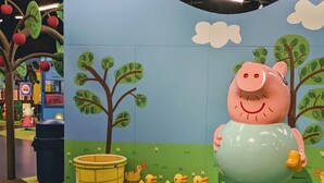 A children's play area with a large pig sculpture, trees, and a yellow barrel. - Luxury Living at its Finest 3bd/3.5ba (Flower Mound)