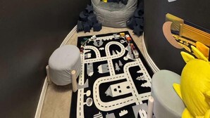 A child's playroom with a black and white play mat, a bean bag chair, and disco balls on the ceiling. - 6BD Luxury Retreat w Backyard & Access Golf Course (Frisco)