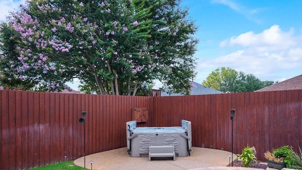 A backyard with a hot tub, a swimming pool, and a wooden fence. - Modern and Luxury DFW Mansion With Backyard Oasis (Fort Worth)