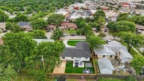 A residential area with houses, a parking lot, and a small commercial building. - Modern Open-concept 4-bd/3-ba With backyard (Irving)