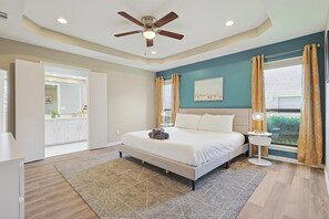 A bedroom with a bed, a ceiling fan, a window with curtains, and a view of the outside. - Best of Allen at Fountain Park 5-bd/2-ba w/ Pool (Allen)