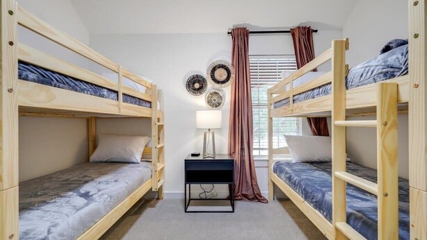 A room with bunk beds, a desk, and a lamp. - Live Like Royalty - Highland Village 6BR Mansion (Lewisville)