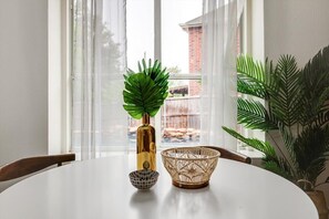 A dining table with a decorative bowl, a patterned bowl, and a potted plant. - Live Like Royalty - Highland Village 6BR Mansion (Lewisville)
