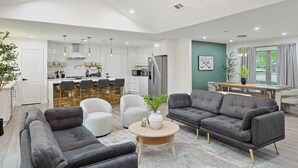 A modern living room with a sofa, armchairs, and a coffee table. - 3-bd Backyard Oasis w Pool, Patio, Firepit (Irving)