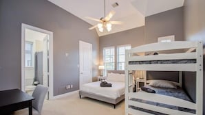 A bedroom with a bunk bed, a desk, and a chair. - High End In The Center - Mins to Downtown w Pool (Houston)