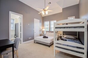 A bedroom with a bunk bed, a desk, and a chair. - High End In The Center - Mins to Downtown w Pool (Houston)