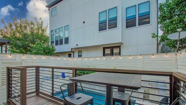 A deck with a pool table, chairs, and a small pool. - High End In The Center - Mins to Downtown w Pool (Houston)