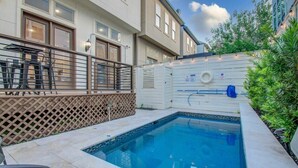 A residential pool area with a small pool, a wooden fence, and a metal railing. - High End In The Center - Mins to Downtown w Pool (Houston)