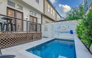 A residential pool area with a small pool, a wooden fence, and a metal railing. - High End In The Center - Mins to Downtown w Pool (Houston)