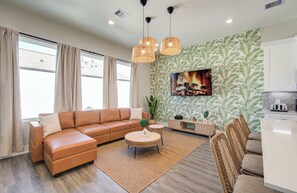 A modern living room with a sofa, coffee table, and dining area. - Chic & Central 3-bd/2.5-ba, Mins to DT & Midtown (Houston)