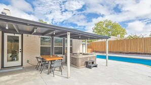 An outdoor patio with a pool, a covered seating area, and a hot tub. - Gorgeous Sunny Home for Big Groups w/ Private Pool (Garland)