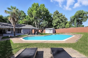 A backyard with a swimming pool, a wooden deck, and a small shed. - Best of Desoto, 5br, 2BA With Pool, Hot Tub, Patio (DeSoto)