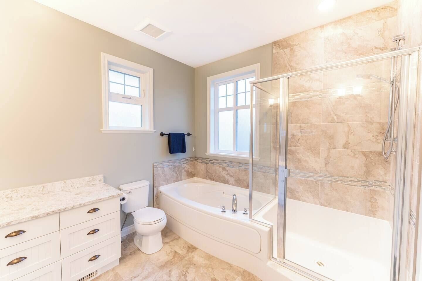 A bathroom with a toilet, bathtub, and shower.