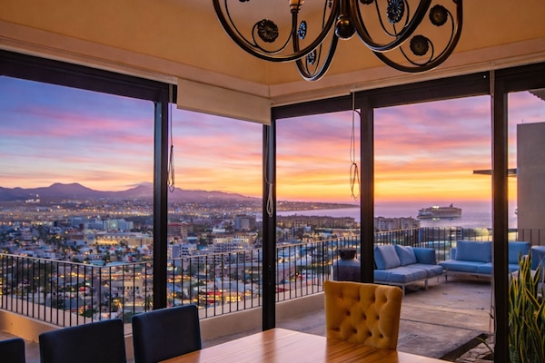 Dining room with floor-to-ceiling sunset views
