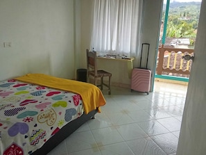 A bedroom with a bed, a desk, a chair, and a suitcase. - Room-charming Guest Room With Stunning V (Jardin)