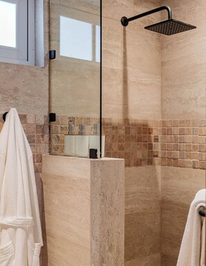 A modern bathroom with a glass-enclosed shower, a tiled wall, and a towel rack. - Stylish Roma Norte Loft + Concierge (Ciudad de mexico)