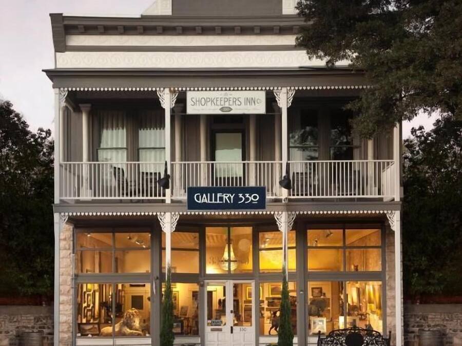 A two-story building with a shopkeeper's sign and a gallery sign.