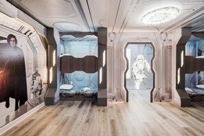 A room with a Star Wars theme, including a mural, a bed with a unique headboard, and a ceiling with a circular design. - Themed Kids Bedrooms | Theater Area | No Rear Neighbors (Kissimmee)