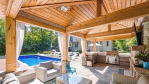 A covered outdoor area with a pool, lounge furniture, and a barbecue grill. - Luxury Private Estate Retreat. 
Pool • Hot Tub • Gym • Pool Table (Halton Hills)