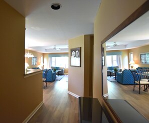 A spacious living area with a sofa, chairs, a coffee table, and a dining table. - Brigantine Quarters, Shipyard, Pool & Beach Access (Hilton Head Island)
