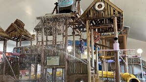 A water play area with a wooden structure, a water slide, and a water fountain. - Lakefront home in Osage Beach - Newly Renovated (Osage Beach)