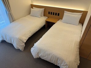 Deluxe Twin Room, Balcony | In-room safe, desk, laptop workspace, blackout drapes