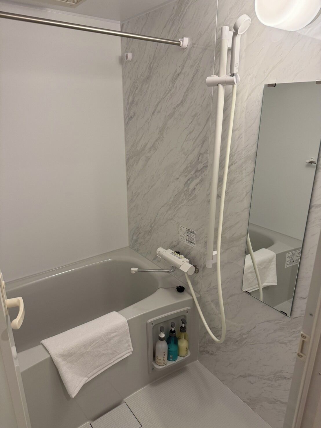 Separate tub and shower, hair dryer, towels, shampoo