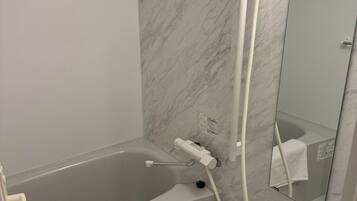 Separate tub and shower, hair dryer, towels, shampoo