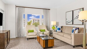 A hotel room with a sofa, two armchairs, a coffee table, a lamp, and artwork on the wall. - ORLANDO RESORT VILLA 2BR MARRIOTT GRANDE VISTA SLEEPS 8 (Orlando)