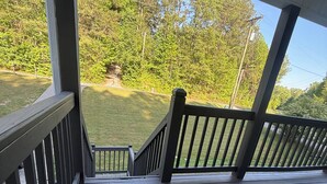A wooden deck with a doormat, railings, and a view of a grassy yard and trees. - Beautiful family house with 3-bedroom  in excellent Ringgold (Ringgold)
