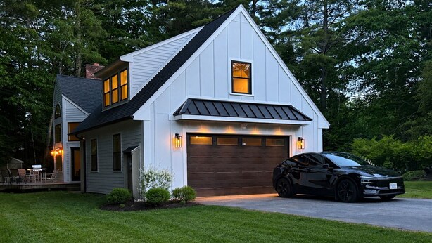 A modern two-story house with a garage, a driveway, and a black car parked in front. - Four-Season Lake Winnipesaukee Retreat (Laconia)