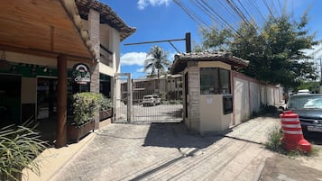 A gated entrance with a building featuring a tiled roof and a sign that reads 'Casa Filia Pizzeria.'