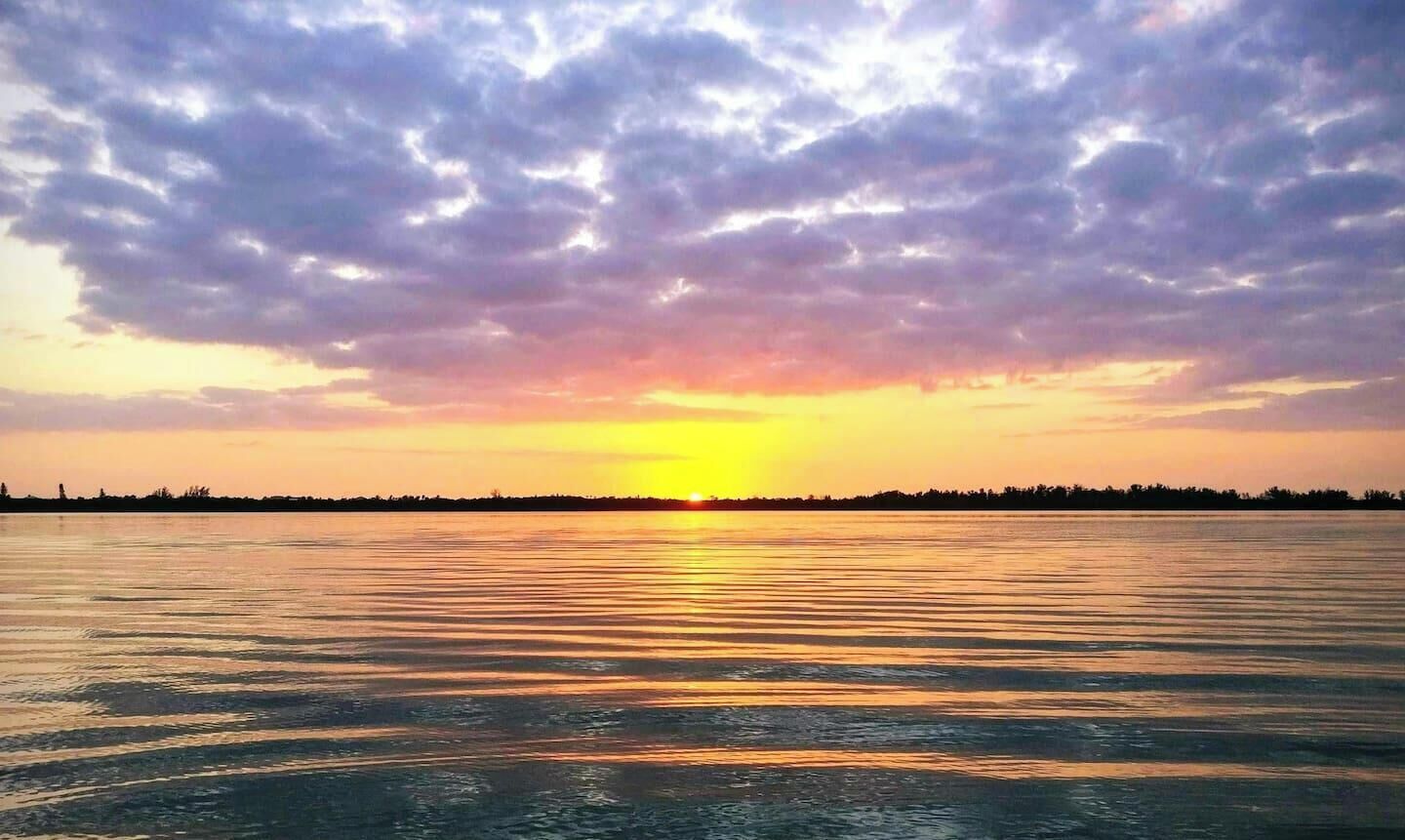 The winter sun sets over Lemon Bay, as seen from the mouth Lake Drive's private canal. Spectacular views like this happen daily, and are best taken in from a kayak or paddleboard.