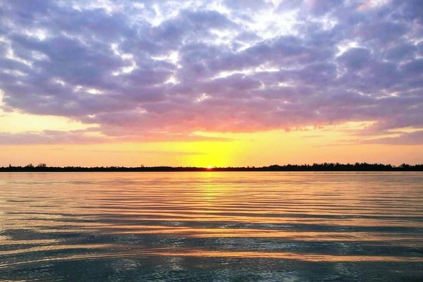 The winter sun sets over Lemon Bay, as seen from the mouth Lake Drive's private canal. Spectacular views like this happen daily, and are best taken in from a kayak or paddleboard.
