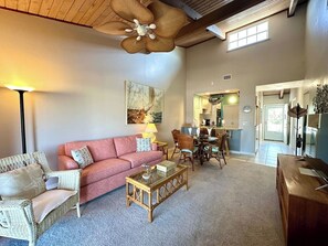 A spacious living area with a sofa, chairs, a coffee table, and a dining table. - Spot manatees from your balcony (Englewood)