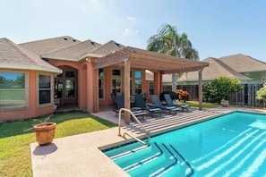 A swimming pool with a covered patio area, lounge chairs, and a small garden. - Villa MeMe with private pool  - 89BP (Laguna Vista)