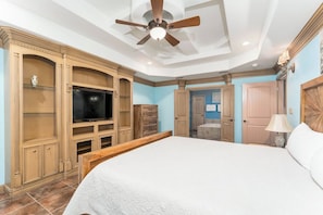 A bedroom with a large bed, a ceiling fan, built-in entertainment system, and a walk-in closet. - Villa MeMe with private pool  - 89BP (Laguna Vista)