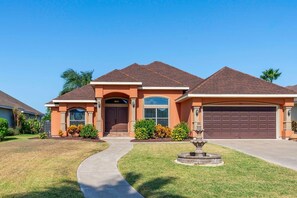 A residential house with a driveway, a garage, and a well-maintained lawn. - Villa MeMe with private pool  - 89BP (Laguna Vista)