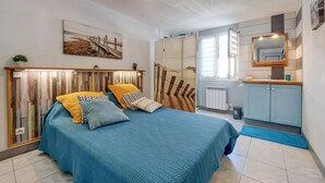 A bedroom with a bed, a bedside table, a mirror, a radiator, and a window. - 1 bedroom beautiful home in Rivedoux-Plage (Rivedoux-Plage)