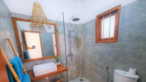 A bathroom with a shower, toilet, sink, and a mirror. - Ohana Surf Guest House (Ahangama)