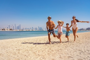 A beach with a city skyline in the background.