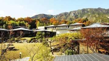 A residential area with houses, a mountain in the background, and a clear sky.