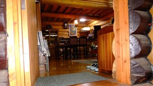 A wooden interior with a staircase leading to a dining area. - Hitomoshi no Sato (Nanae)
