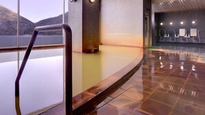 A modern indoor swimming pool with a clear view of the mountains outside. - Shikaribetsu-kohan Onsen Hotel Fuusui (Shikaoi)