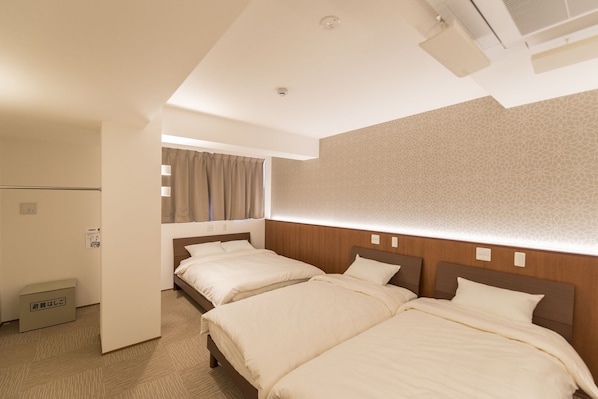 A hotel room with two beds, a small kitchenette, and a patterned wall. - Coco Shuku Nakano (Tokyo)