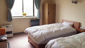 A hotel room with two beds, a desk, a wardrobe, a TV, and a window with curtains. - Business Hotel Yamatoya (Iizuka)