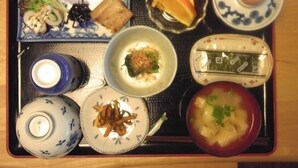A tray with various Japanese dishes including sushi, soup, and a bowl of noodles. - Business Hotel Yamatoya (Iizuka)