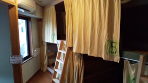 A narrow corridor with bunk beds, a ladder, and a window. - Moritomizu Backpackers (Nagano)